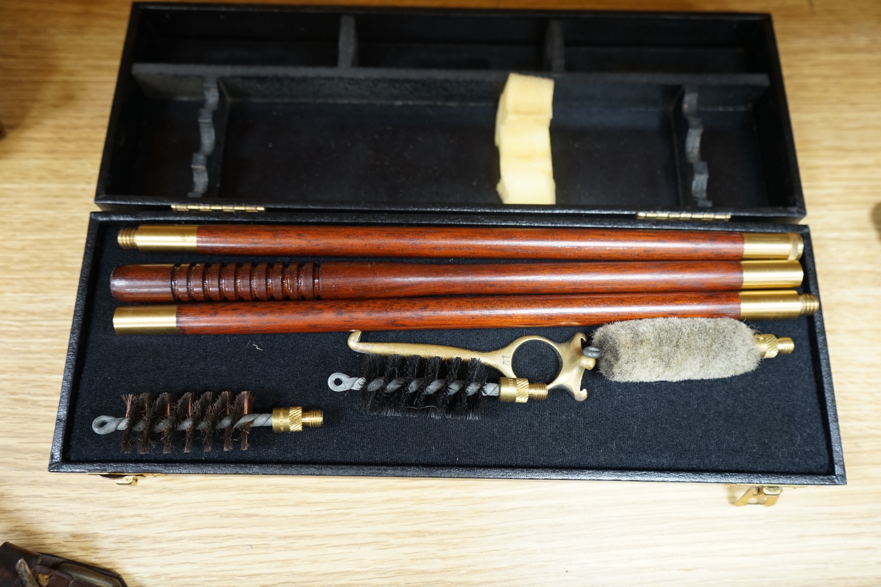 Two cases of gun cleaning equipment and a 19th century leather gun case, 83cm long. Condition - fair to good